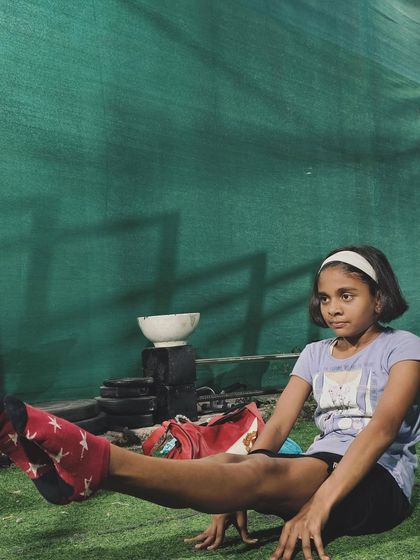 Building a strong core is key to all advanced movements. Here, one of our young members works on her L-sit, showing the concentration it takes to succeed.