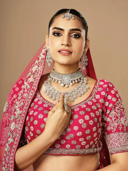 This bride's makeup is all about diamond-like radiance. The clean skin, sharp liner, and sparkling jewelry come together for a glamorous reception or cocktail party look.