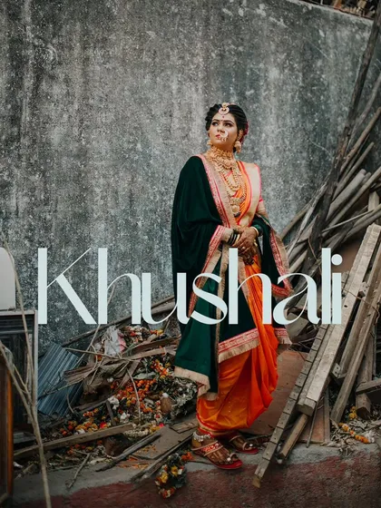 An artistic and unconventional bridal portrait, placing the bride in her traditional Nauvari against a rustic, deconstructed background.