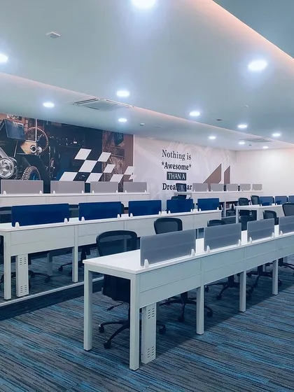 The interior of the TVS Car Auction Centre in Madhavaram, designed for a modern and efficient user experience. The open-plan layout, clean lines, and integrated technology create a professional environment for high-value commercial transactions.