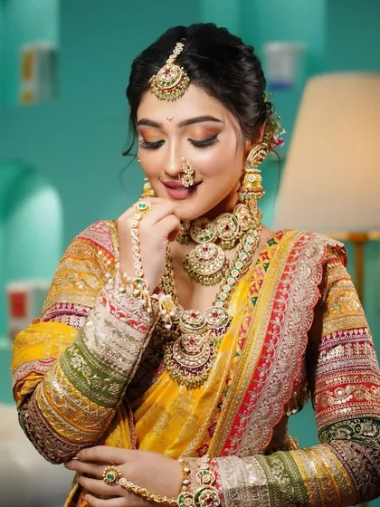 A moment of quiet elegance. The bride's makeup is subtle yet stunning, with a focus on flawless skin and soft tones that enhance her natural beauty.