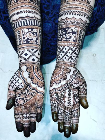 A beautiful design from an Eid henna session. The mix of bold, dark-filled areas and delicate white space creates a striking contrast.
