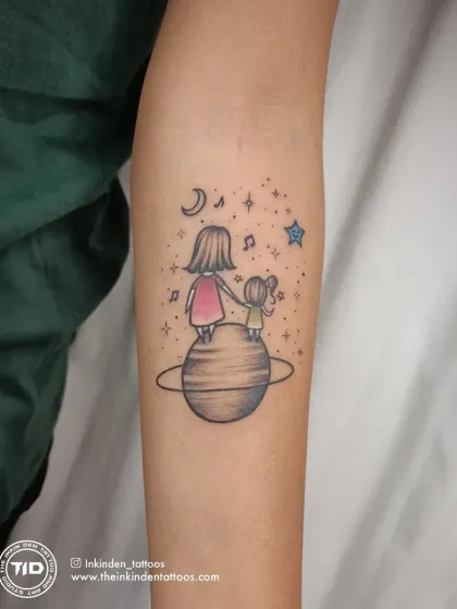 A deeply personal family memorial tattoo. It depicts a mother and daughter standing on a planet, looking up at a guiding star that represents their late father and husband, with musical notes echoing his memory.