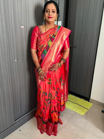 A full-length shot showing the simple yet elegant makeup and hair, which perfectly complements her beautiful printed saree.
