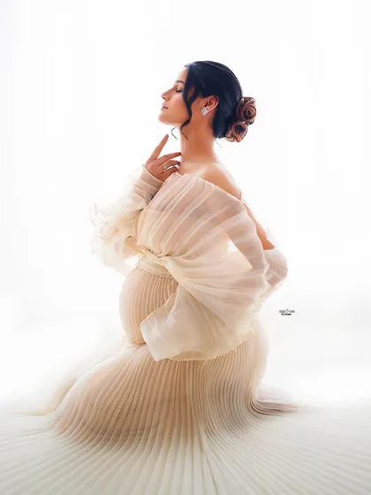 A dramatic and artistic pose in our pleated white gown. This shot feels like it belongs in a high-fashion magazine.