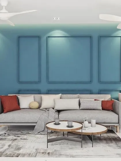 Don't be afraid of color. In this design concept, a deep teal accent wall with decorative molding adds depth and character to the living room. I balanced the bold wall with a neutral grey sofa and clean, white storage units to create a look that is both sophisticated and full of life.