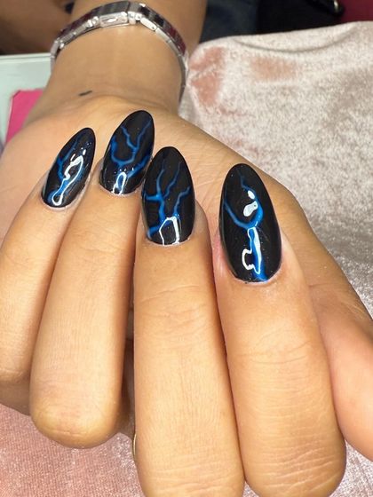 A bold design with black polish and blue lightning bolt art.
