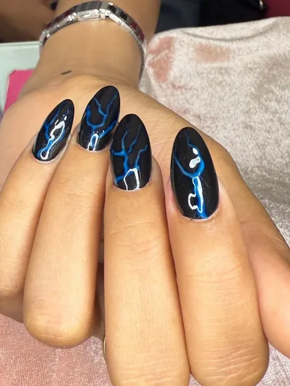 A bold design with black polish and blue lightning bolt art.