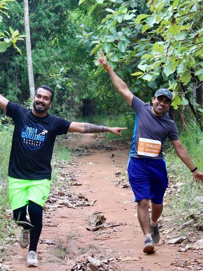 Sharing a moment of joy and encouragement with a fellow runner on the trail. The ultra running community is built on this kind of mutual support.
