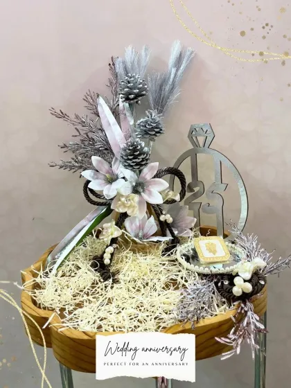 A sophisticated hamper perfect for a wedding anniversary. The silver and white color scheme, complete with a custom "21st" motif, creates a truly elegant and memorable gift.