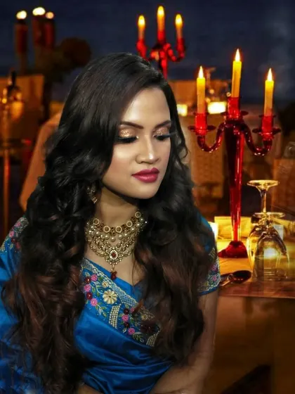 The warm lighting of the candles enhances the golden highlighter and shimmery eyeshadow.
