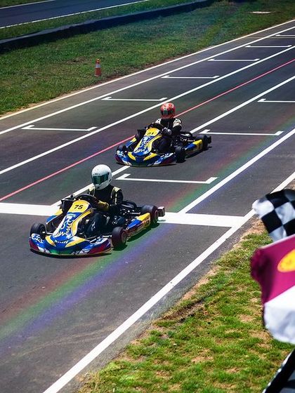 A driver crosses the finish line, marking the end of another intense race.