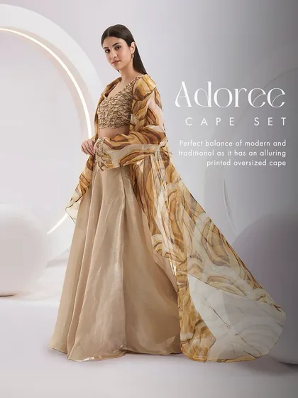 The Adoree Cape Set in a beautiful beige print, offering a perfect balance of modern and traditional with its alluring oversized cape.