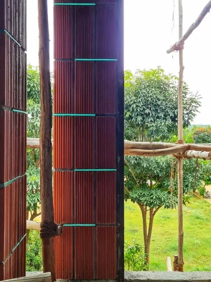 A close-up of a wall during construction, showing the "break joint" pattern of hollow clay blocks. This detail highlights the technical side of using sustainable materials and the clean, linear aesthetic they can produce.