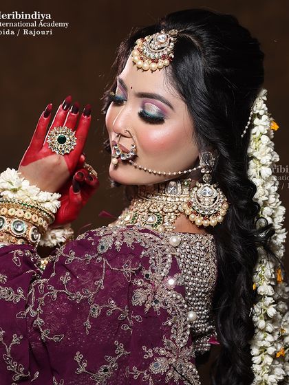 This classic over-the-shoulder pose highlights the flawless back, hair, and side profile makeup, ensuring the bride looks perfect from every angle.