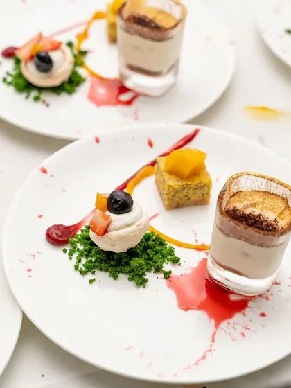 The full view of the dessert plates ready to be served at a 50th birthday party. Consistency and elegance are key when catering for a large group.