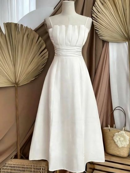 For a more formal Western look, I designed this elegant white midi dress. The structured bodice features intricate pleating and ruching for a sophisticated texture, flowing into a graceful A-line skirt. It’s a testament to how tailoring can elevate a simple design.