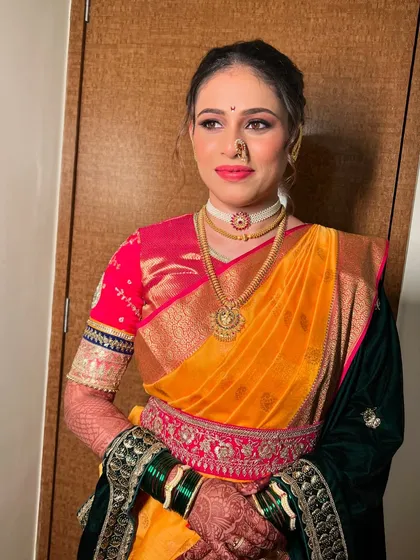 A traditional nauvari look with a velvet shawl, perfect for a winter wedding.