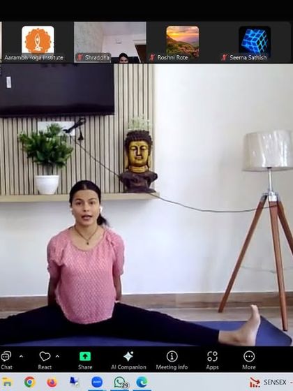 An instructor demonstrates Upavistha Konasana (Wide-Angled Seated Forward Bend) in the stress management workshop. This pose helps to release tension in the hips and calm the nervous system.