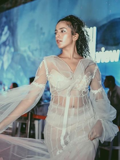 A model walks the runway at our URBN night, where fashion meets music. I curate unique event concepts that blend different creative industries for a multi-sensory experience.