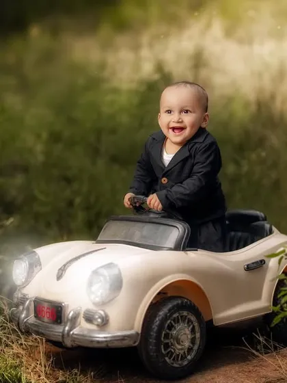 A joyful ride through a magical forest. The lighting effects in this photo add a touch of fantasy to this little boy's adventure in his toy car.