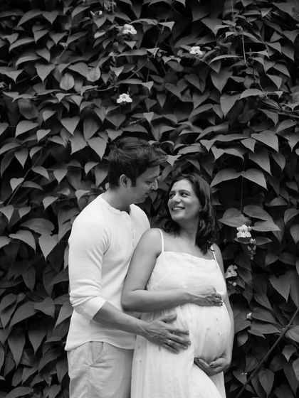 A beautiful portrait of the couple against a wall of leaves. The contrast in this black and white image highlights their loving gaze and the beauty of the natural setting.