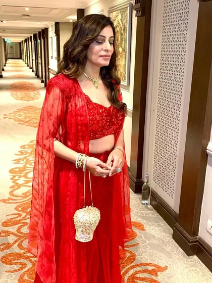 A glamorous red-hot look for an evening sangeet party. The makeup is bold and sophisticated, perfect for making a statement.