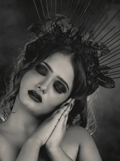 A sleeping pose in black and white, showcasing the dark queen makeup. The closed eyes draw attention to the blended smokey eyeshadow and the overall serene yet gothic aesthetic.