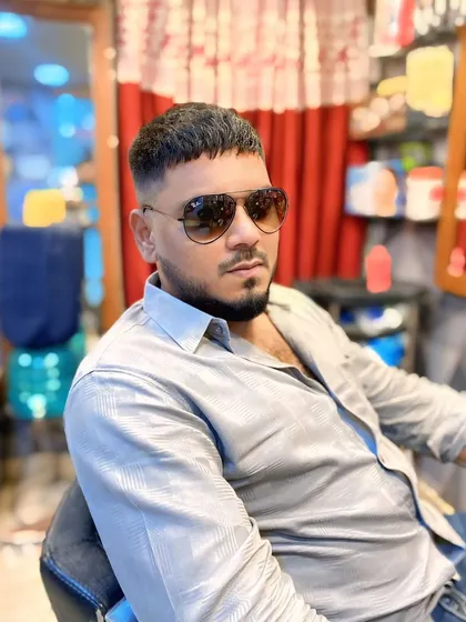 A three-quarter view of the finished men's crop and fade. The look is completed with a sharp beard lineup for a polished finish.