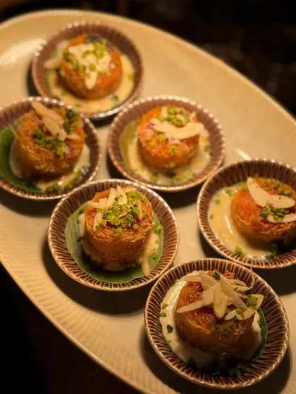 Middle Eastern dessert dreams. These bite-sized portions of crispy, cheesy Künefe are served in individual bowls, offering a taste of pure edible bliss.