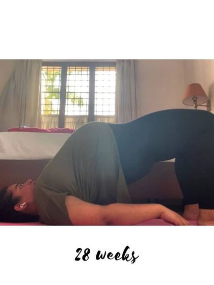 A supported Bridge Pose at 28 weeks, which is a great restorative posture to ease back discomfort.