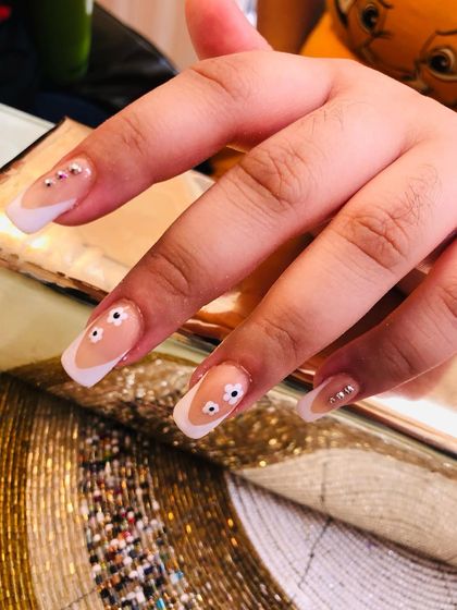 A closer view of the playful googly eye nail art.