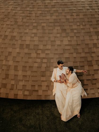 An artistic, high-angle shot of the couple. This unique perspective creates a minimalist and modern feel, focusing on their connection within the architectural space.