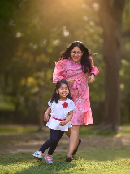 An action shot of a mother and daughter running and laughing together in a park. My sessions are full of movement to ensure the photos feel alive and authentic.