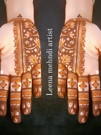The finished Arabic strip design. The pattern runs down the center of the hand, adorned with floral and leaf motifs.