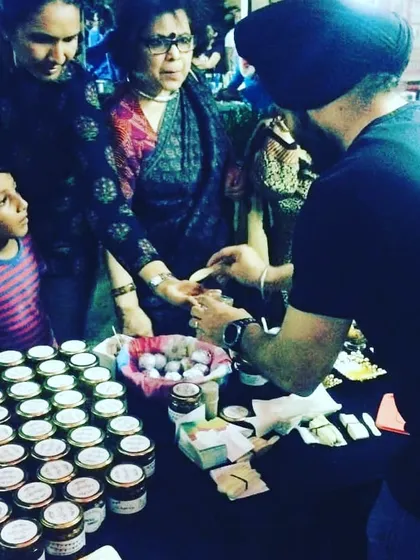 A family tasting my pickles. It's a joy to see people of all ages enjoying my traditional recipes.