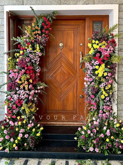 Welcoming guests to a 'shaadi ka ghar' (wedding house) with a stunning floral doorway. We used a vibrant mix of colorful flowers to frame the entrance and create a festive welcome.