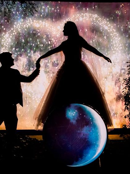 A creative silhouette shot using a unique firework-like light painting background, showcasing the artistic possibilities at our venue.