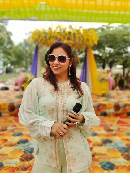 Mic in hand, ready to host a beautiful outdoor wedding event. My pastel outfit blends perfectly with the elegant and dreamy decor.