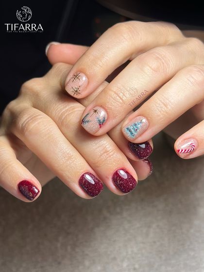 A full view of a whimsical Christmas set, with each nail telling a small festive story through hand-painted art.