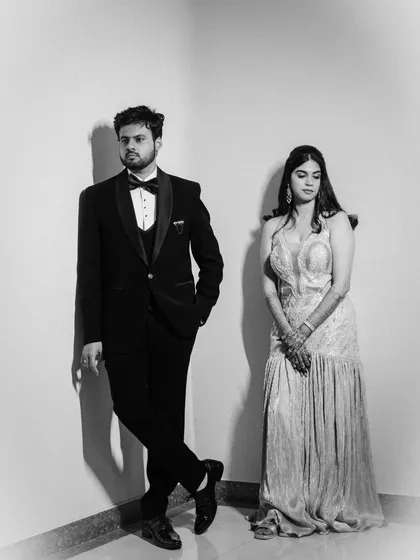 A stylish black and white portrait using strong lines and shadows to create a modern, editorial feel for this glamorous couple.