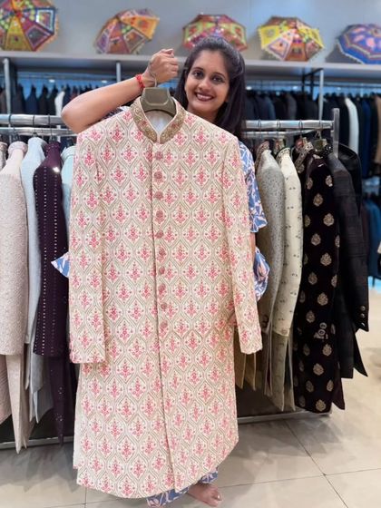 Here’s another option for a fresh, daytime event. This sherwani features a lovely pink and beige pattern, offering a lighter but equally elegant alternative to heavier pieces.