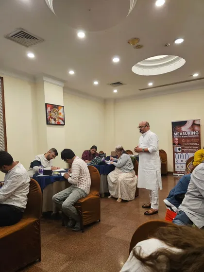 Guiding participants as they work on their personal chakra analysis during the workshop.