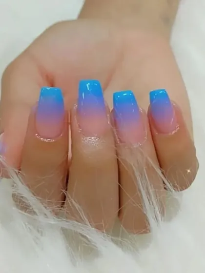A beautiful blue and purple ombré with a jelly finish on square-shaped nails.