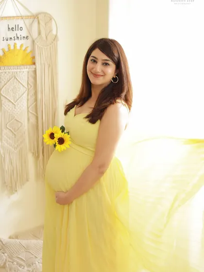 A bright and sunny solo portrait in our Boho studio. The yellow dress, sunflowers, and "Hello Sunshine" decor create a cheerful and optimistic vibe.
