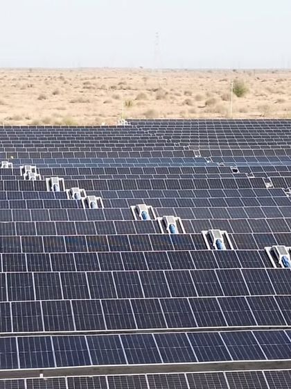 A close-up of the robotic cleaning systems deployed at Project JAI. This technology is crucial for maintaining panel efficiency in arid environments, ensuring consistent energy output and saving approximately 27 million liters of water annually.