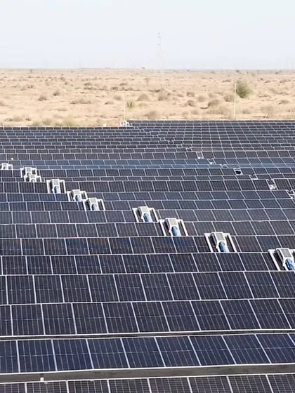 A close-up of the robotic cleaning systems deployed at Project JAI. This technology is crucial for maintaining panel efficiency in arid environments, ensuring consistent energy output and saving approximately 27 million liters of water annually.