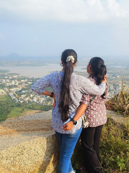 Two friends sharing a moment while looking out at the view from the top.