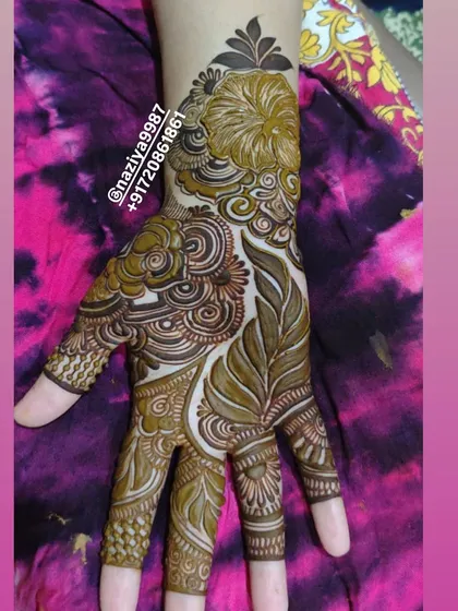 A beautiful, intricate design on the palm with a mix of floral and leafy motifs. The shading and detail are what make this piece special.