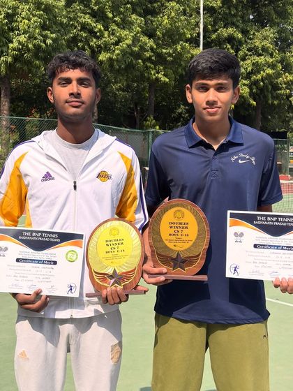 A closer look at the hardware. These trophies represent teamwork, strategy, and the will to win in doubles tennis.